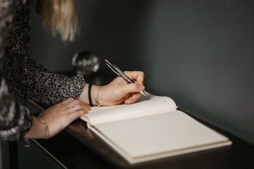 Woman Writing in Notebook